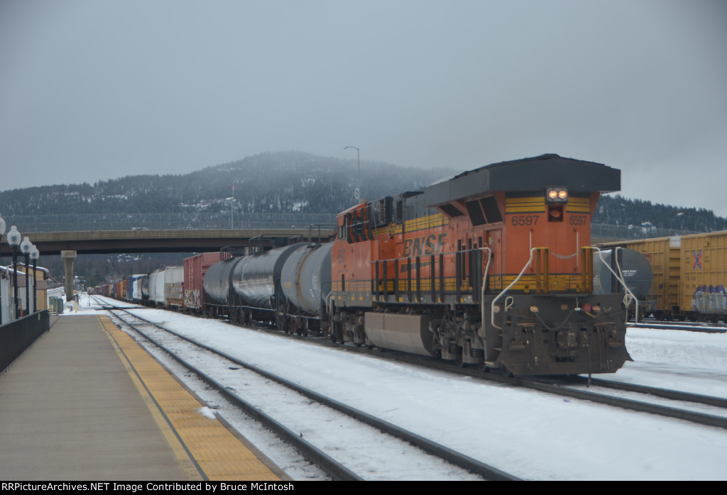 BNSF 6597 shoving hard on the hind end of a westbound leaving Whitefish, MT